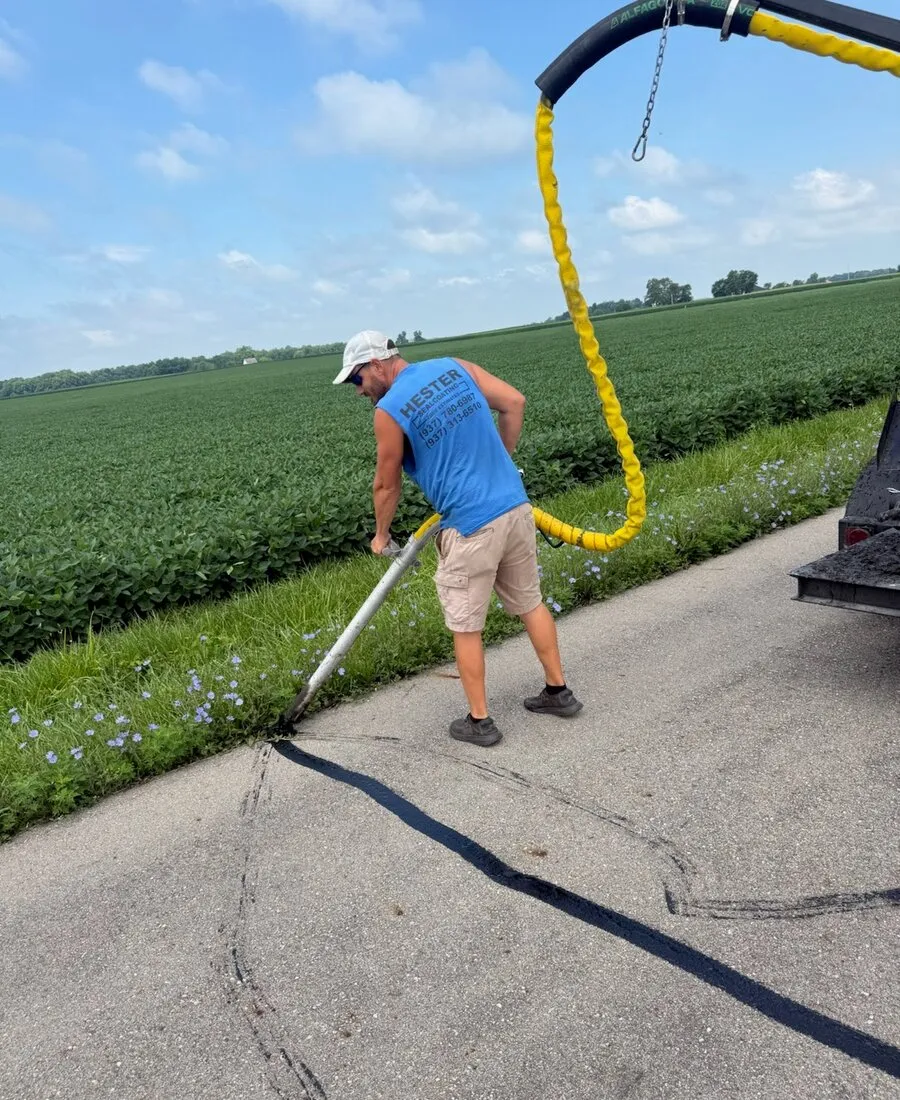 Hester crew member applying sealcoating material